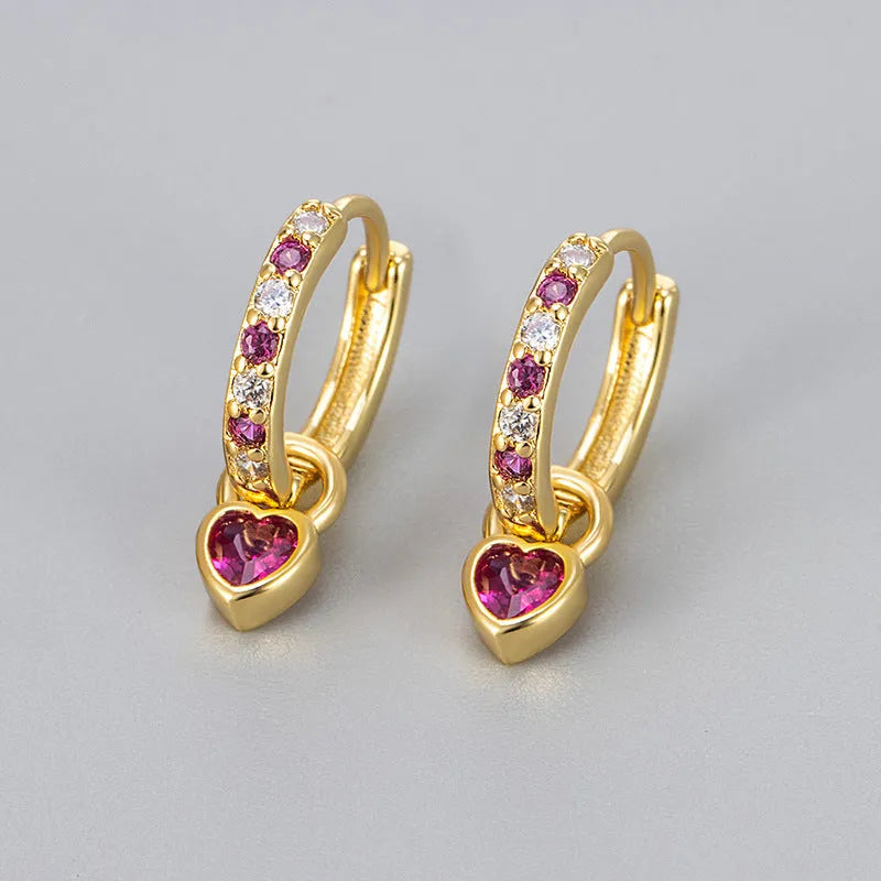 Women's heart-shaped drop earrings with coloured zircon or corundum stone in gold or white gold tone.
