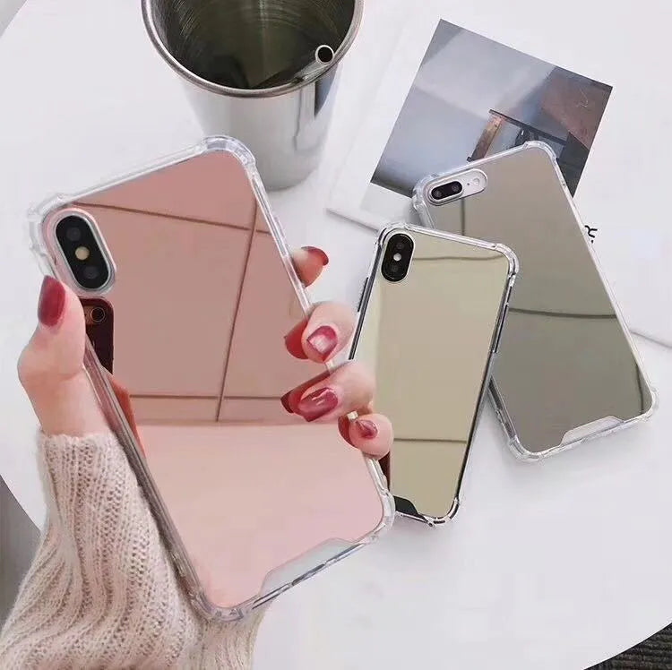 Mirrored front TPU protective case for iPhone in multiple colour options on a table.