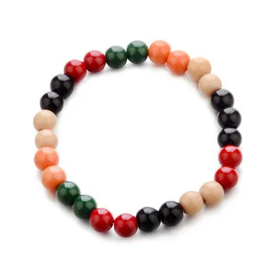 A natural lava stone bead bracelet with an ethnic design on a wrist, showing its porous texture for essential oils.