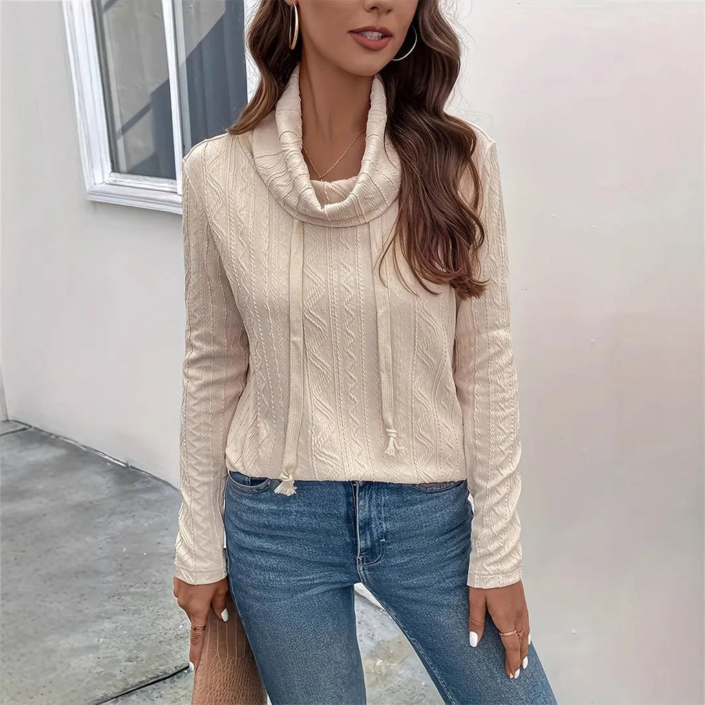 Apricot coloured long sleeve hooded pullover sweater on a hanger