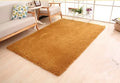 White rectangular plush velvet carpet with a soft pile and dot-patterned non-slip bottom.