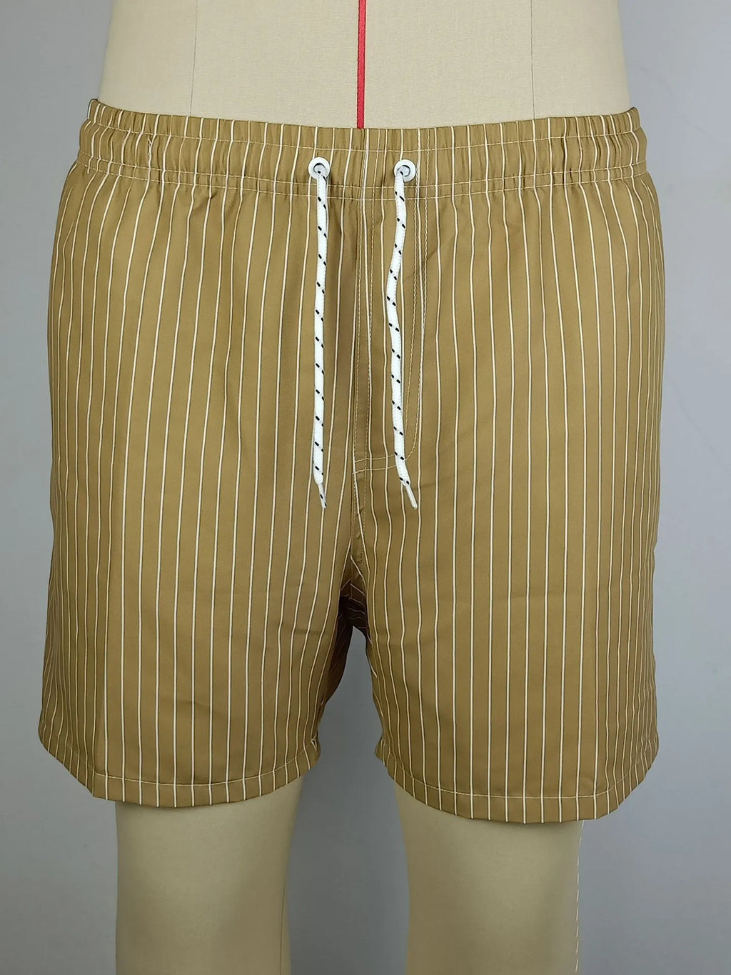 Men's navy blue and grey striped polyester beach shorts with a straight leg cut, laid flat.