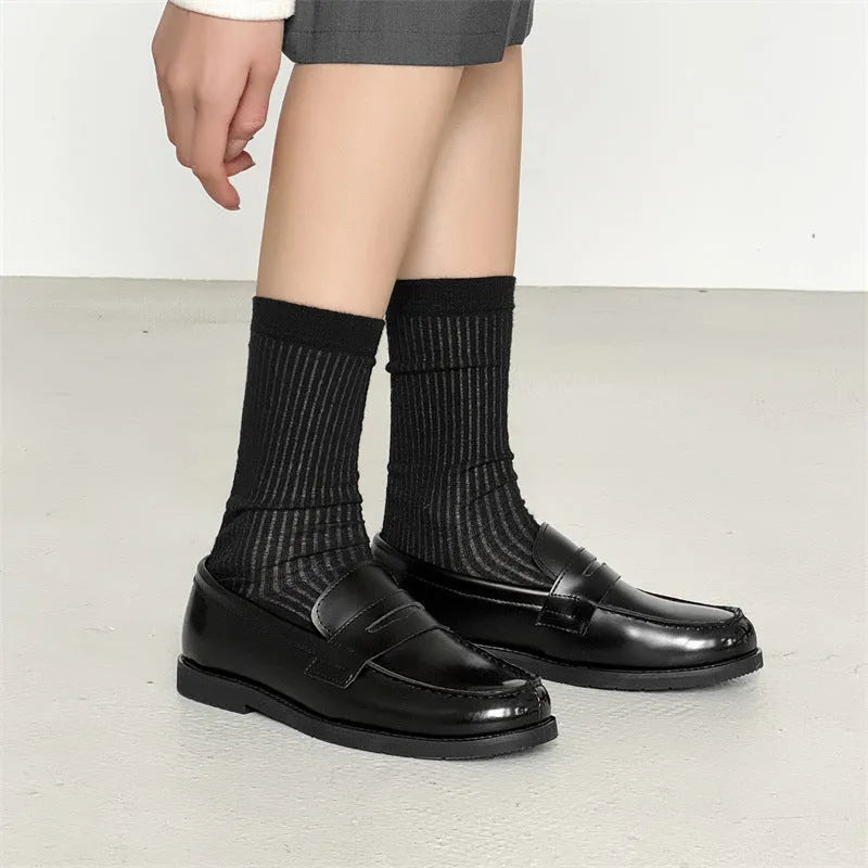Black men's slip-on derby leather shoes with a rubber sole on a white background