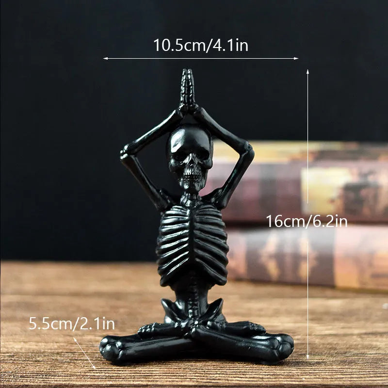 A detailed resin desktop ornament of a yoga-pose skeleton skull in black and white colour options.