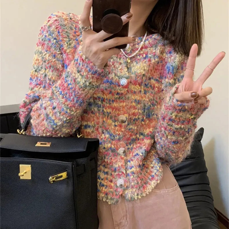 Pink or green retro-style rainbow patterned knitted cardigan on a model.