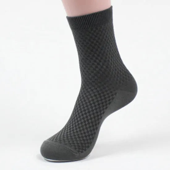 Men's bamboo fibre ankle socks in black with a small square pattern, laid flat.