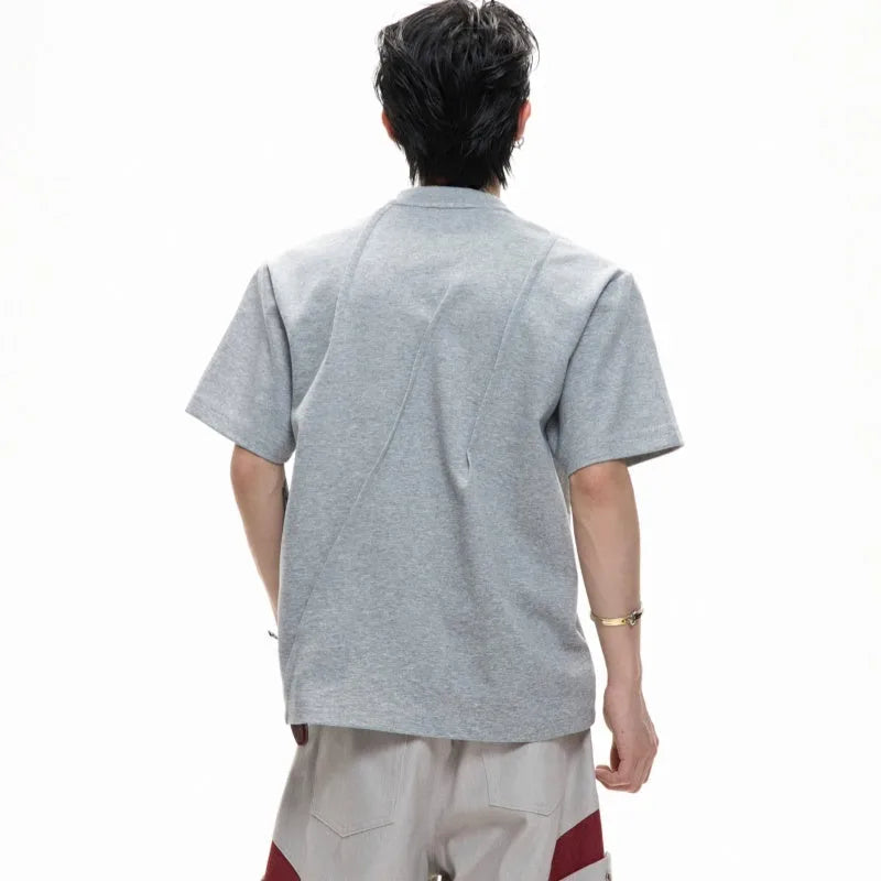 Men's loose grey cotton t-shirt with three-dimensional pleated detail and asymmetric styling