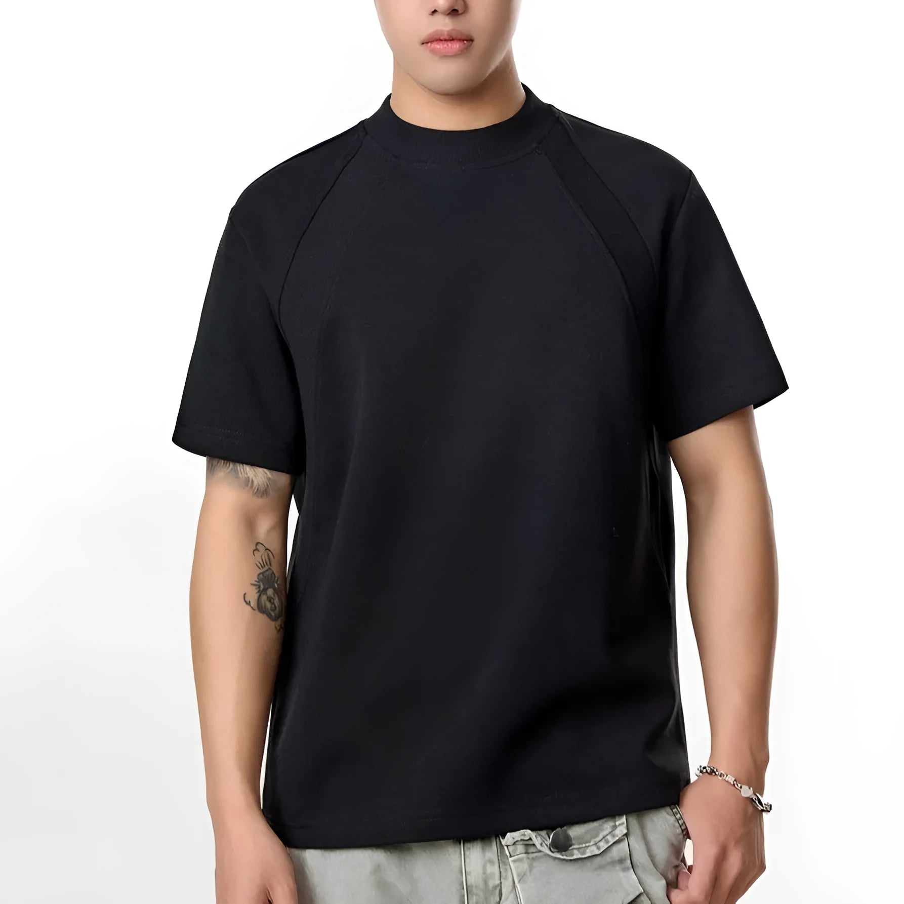 Man wearing a loose-fit black short sleeve top with visible air layer stitching detail.