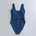 Navy blue women's one-piece triangle swimsuit with chest pads on a mannequin, showing the sleeveless slimming design.
