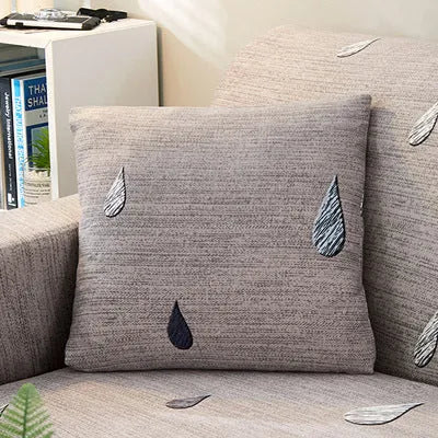 Geometric patterned stretch sofa slipcover on a double seat sofa with matching cushion
