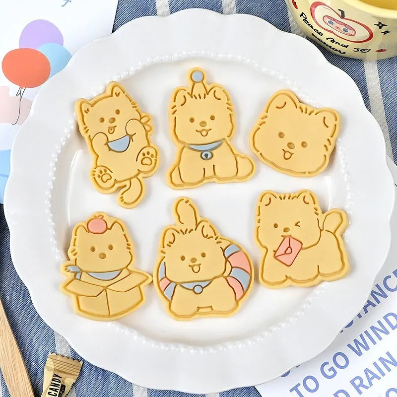 Plastic press mould for making puppy-shaped biscuits and soft candies with cartoon designs.
