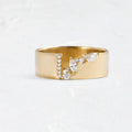 Gold coloured women's ring with a shining zircon stone on a copper band.