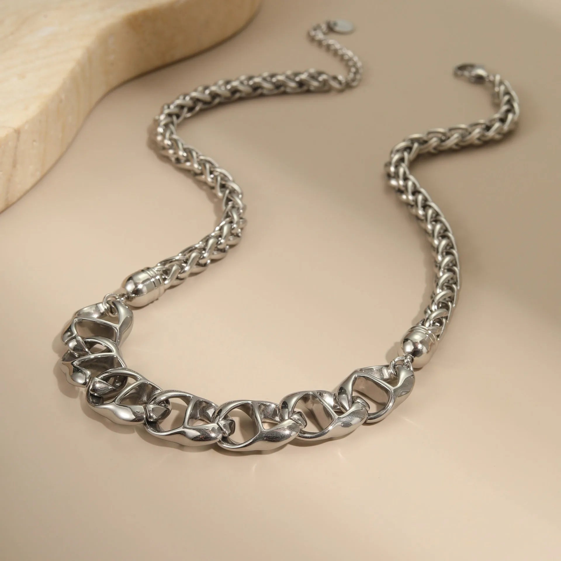 Stainless steel geometric chain necklace with 18K gold plating in gold or steel finish.