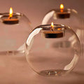Handmade round clear glass candle holder on a table