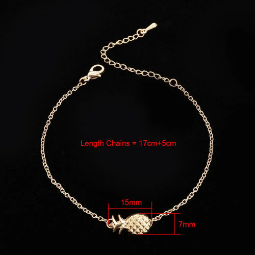 Women's alloy bracelet with a pineapple charm in gold or silver tone on a wrist.