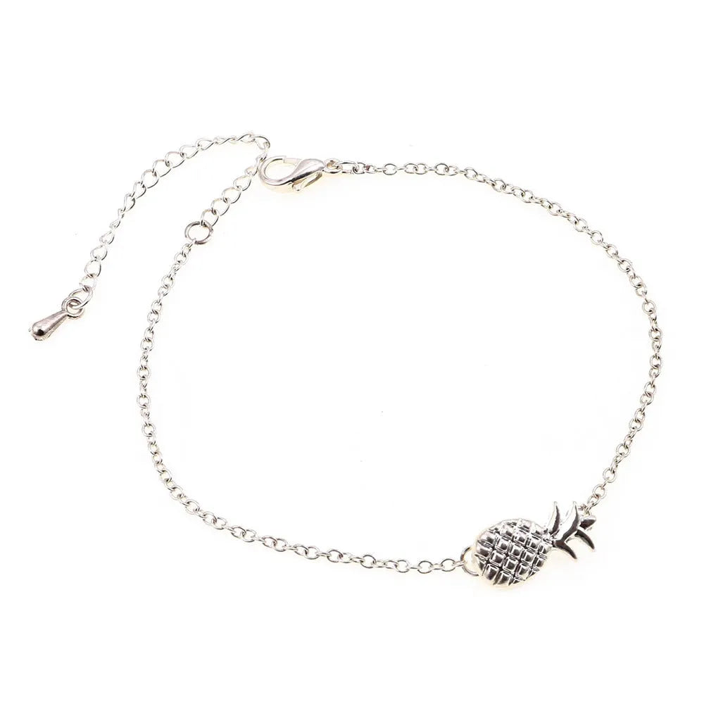 Close-up of a gold-colour alloy bracelet shaped like a pineapple on a wrist.