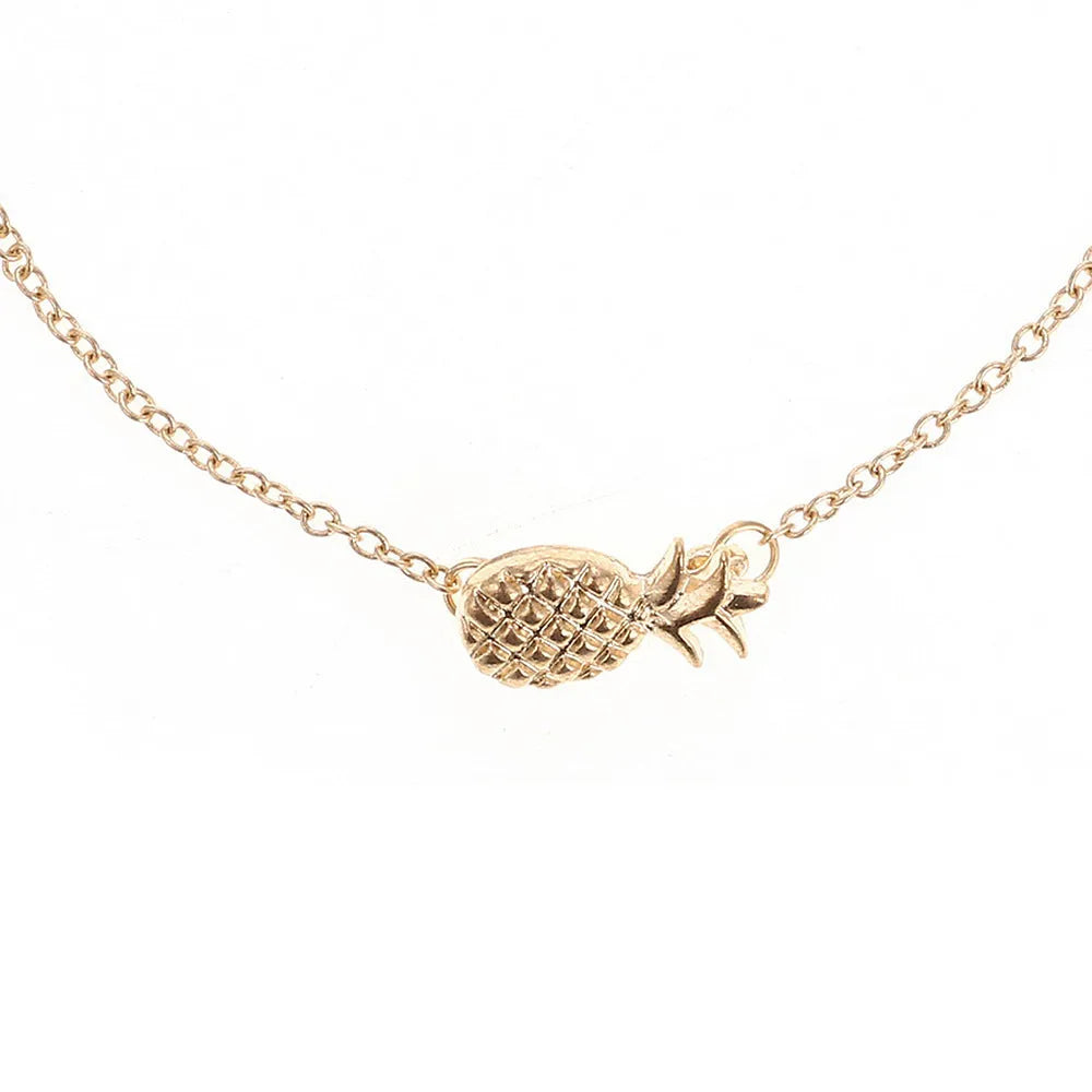 Close-up of a gold-colour alloy bracelet shaped like a pineapple on a wrist.