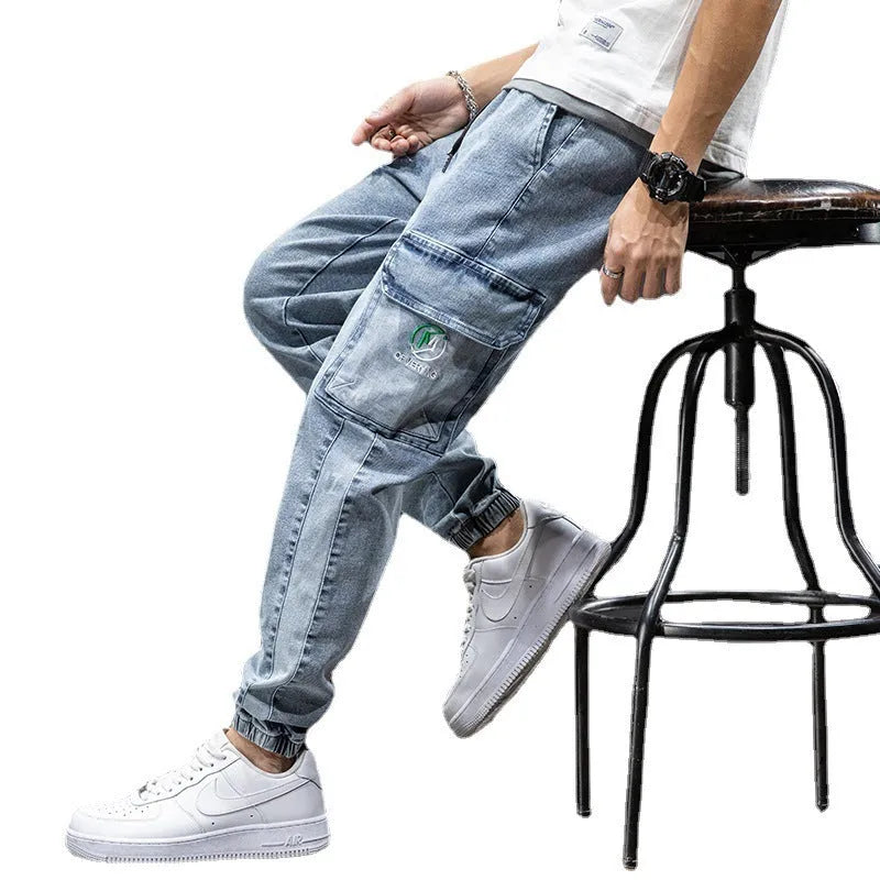 Men's loose blue cargo jeans with straight leg on a neutral background.