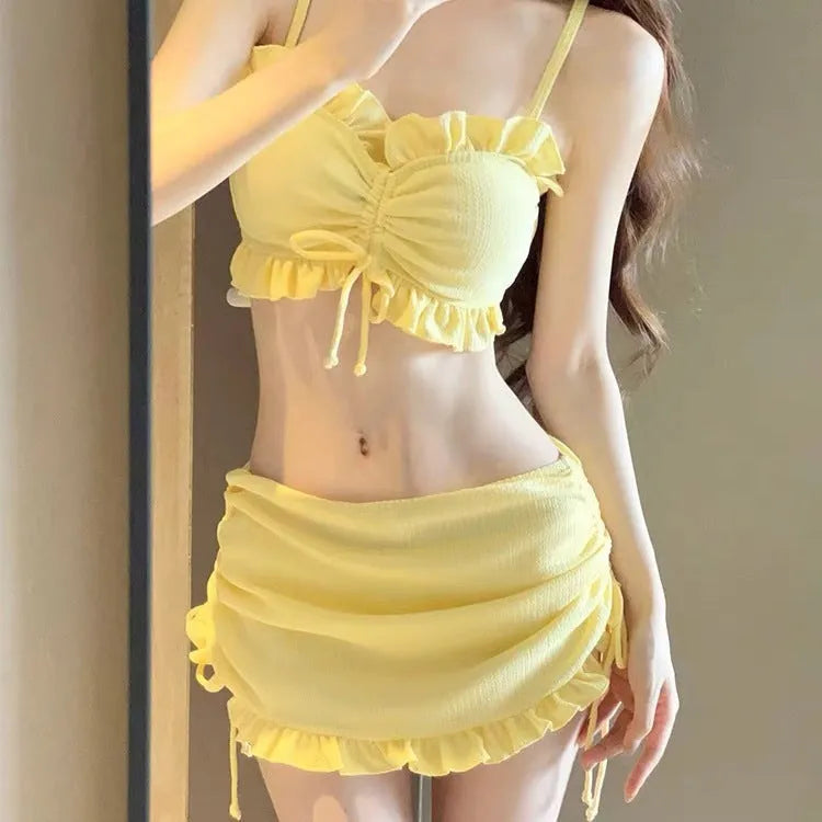 Women's solid colour milk silk bikini swimsuit top and pants on a neutral background.