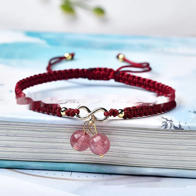 Women's natural strawberry quartz crystal cherry bracelet with adjustable cord on wrist