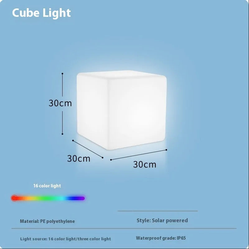 Square LED cube stool light in garden setting showing modern design with lighting