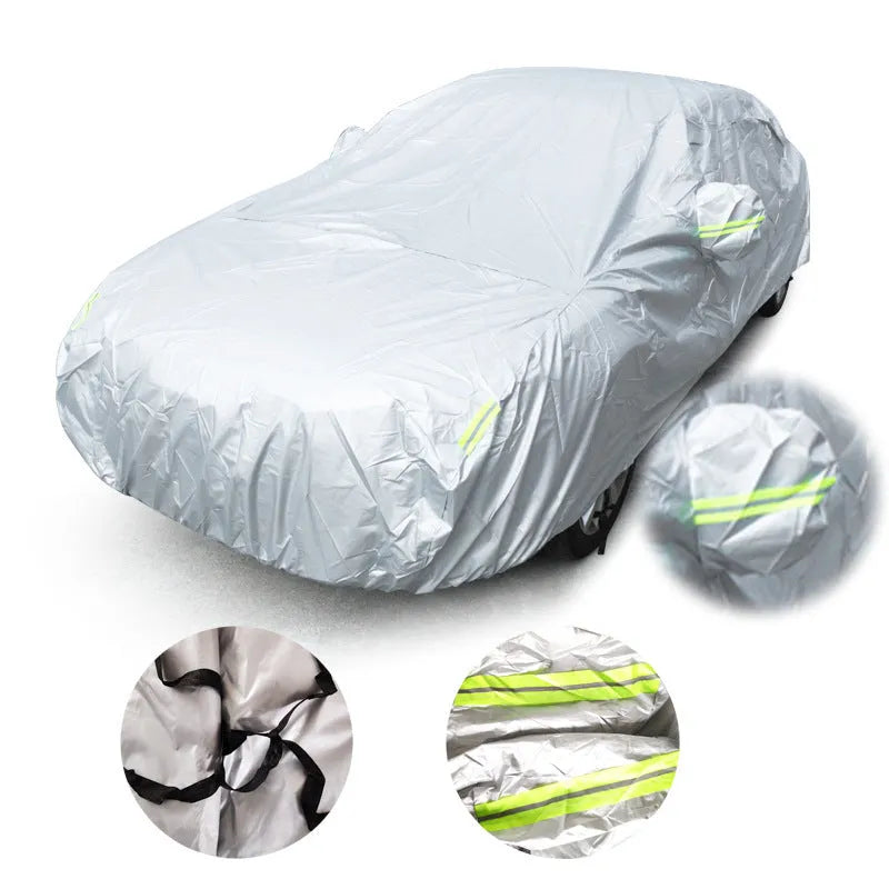 Silver-coated black taffeta universal car cover fitted over a sedan in outdoor parking
