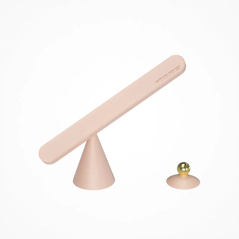 White geometric desk lamp with a magnetic base and touch control, placed on a wooden desk.