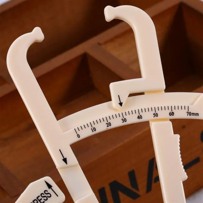 Compact acrylic body fat caliper showing measurement scale up to 200mm on a white background.