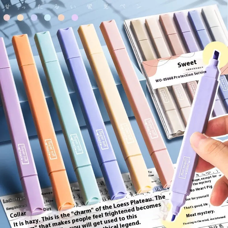 Set of double-tipped fluorescent marking pens in mixed colours on a white background.