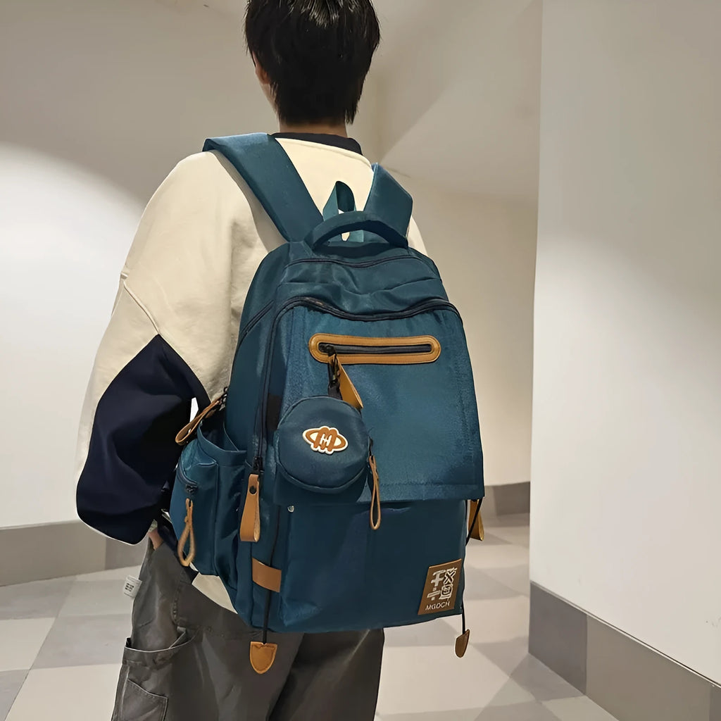 Large-capacity nylon backpack for middle school students in blue colour with curved shoulder straps.