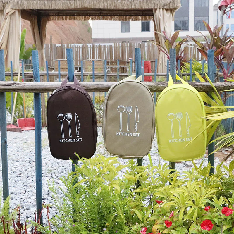 Portable khaki bag containing a 12-piece stainless steel picnic kitchenware set for outdoor dining.