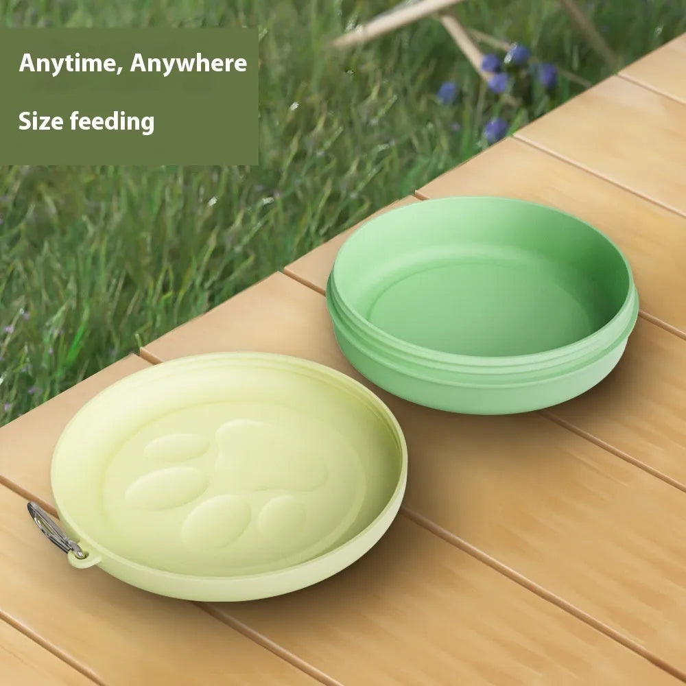 Portable dog feeding bowl with a separate snack box attached, shown in light green and pink colour options.