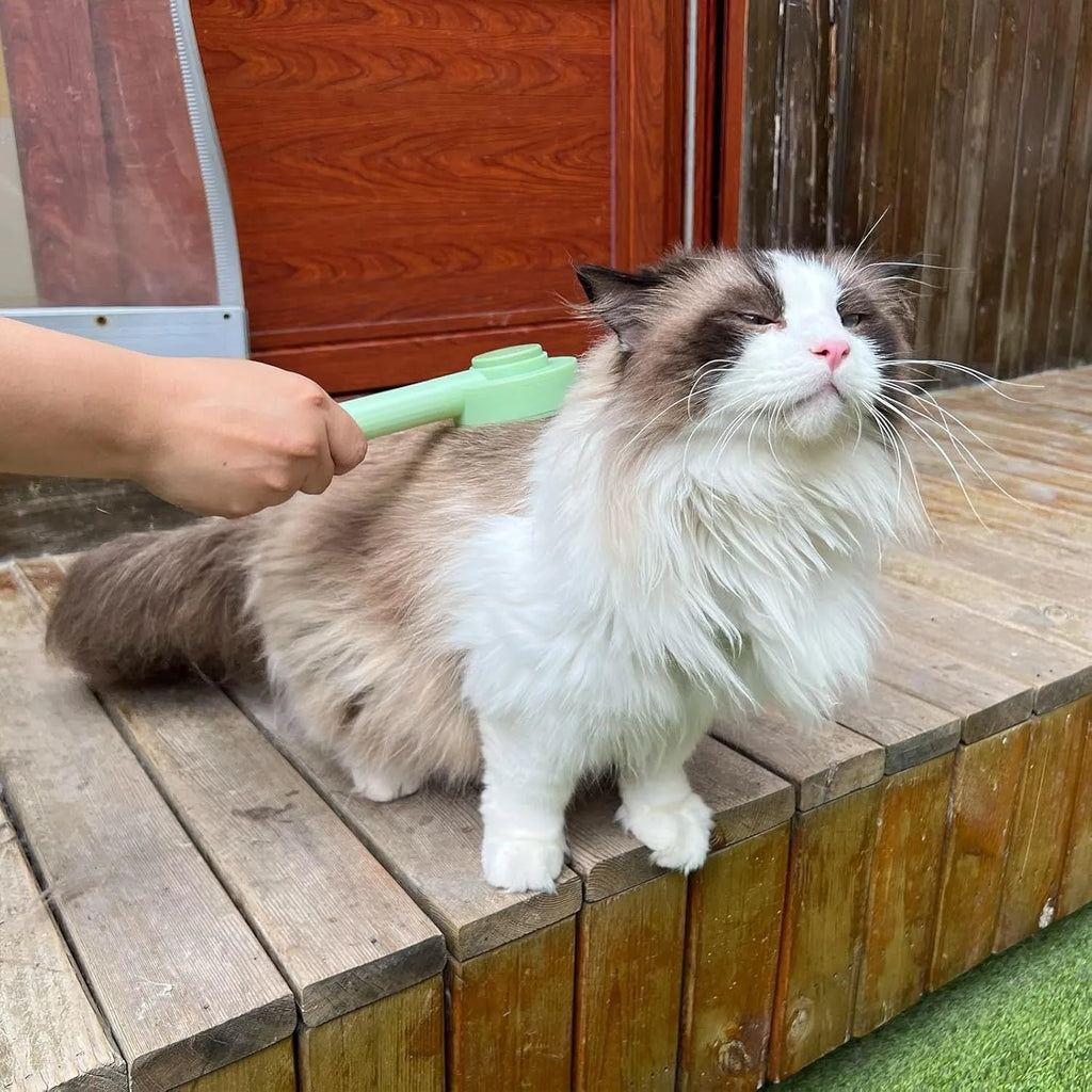 Green and yellow pet grooming brush with stainless steel teeth for deshedding cats and dogs