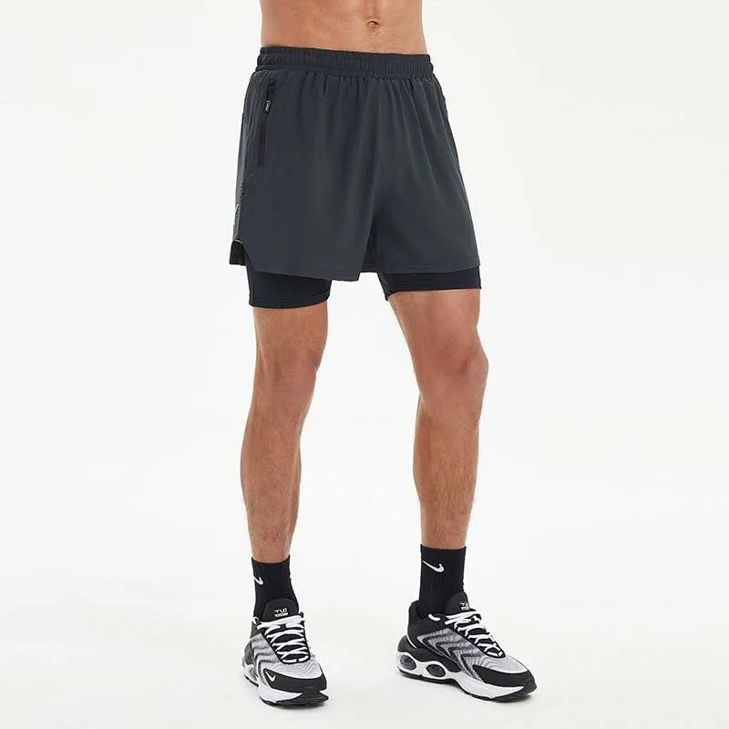 Man wearing black double-layer sports shorts with a spandex liner for running, showing short length and mid waist design.