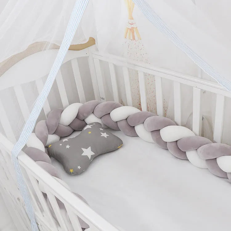 Braided knot style baby cot bumper in spandex crystal velvet fabric, shown in a light grey colour.