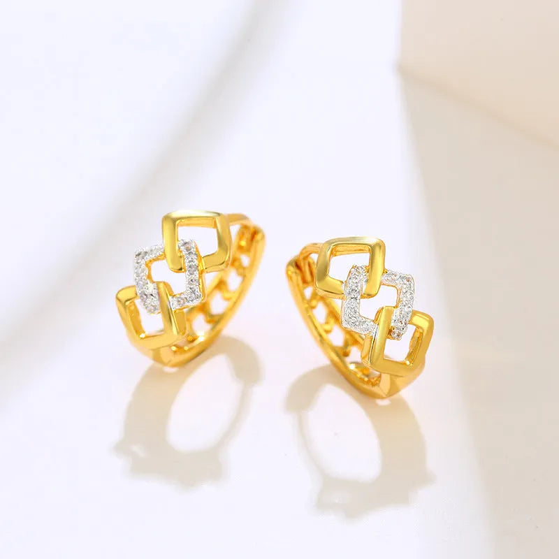Gold geometric hollow-out alloy earrings for women on a plain background.