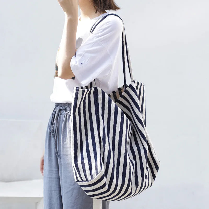 Striped canvas shoulder bag in black, blue, or red with 39cm bottom length, 35cm height, 21cm thickness, and certificate bag.