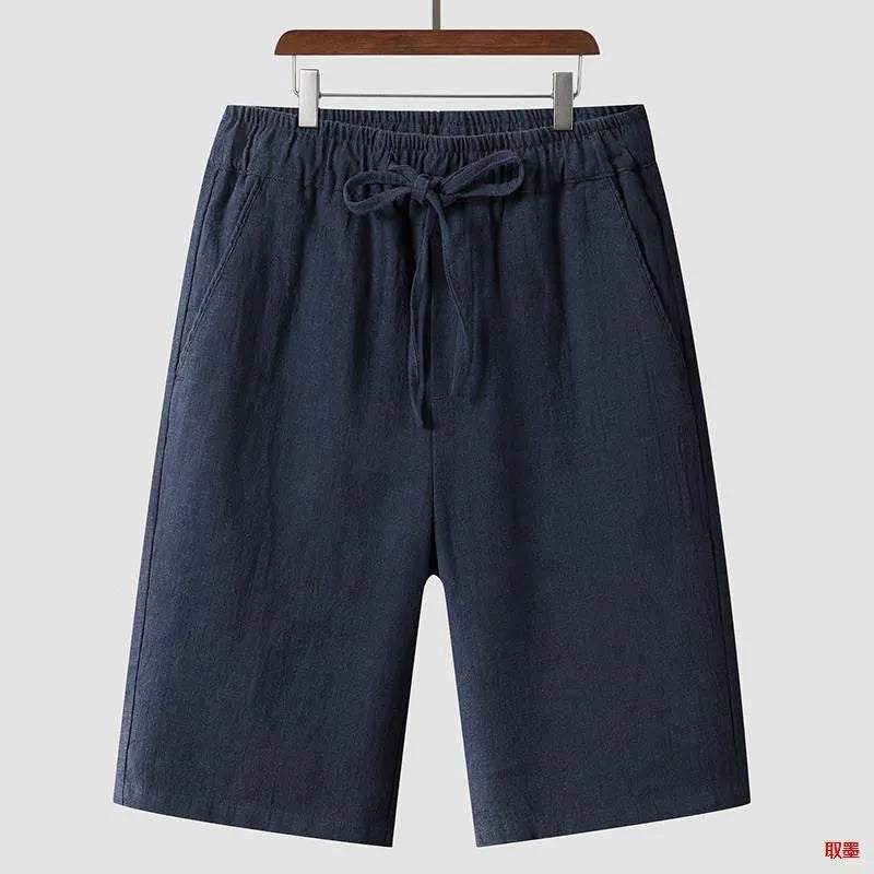 Men's beige linen loose cropped casual shorts on a neutral background.
