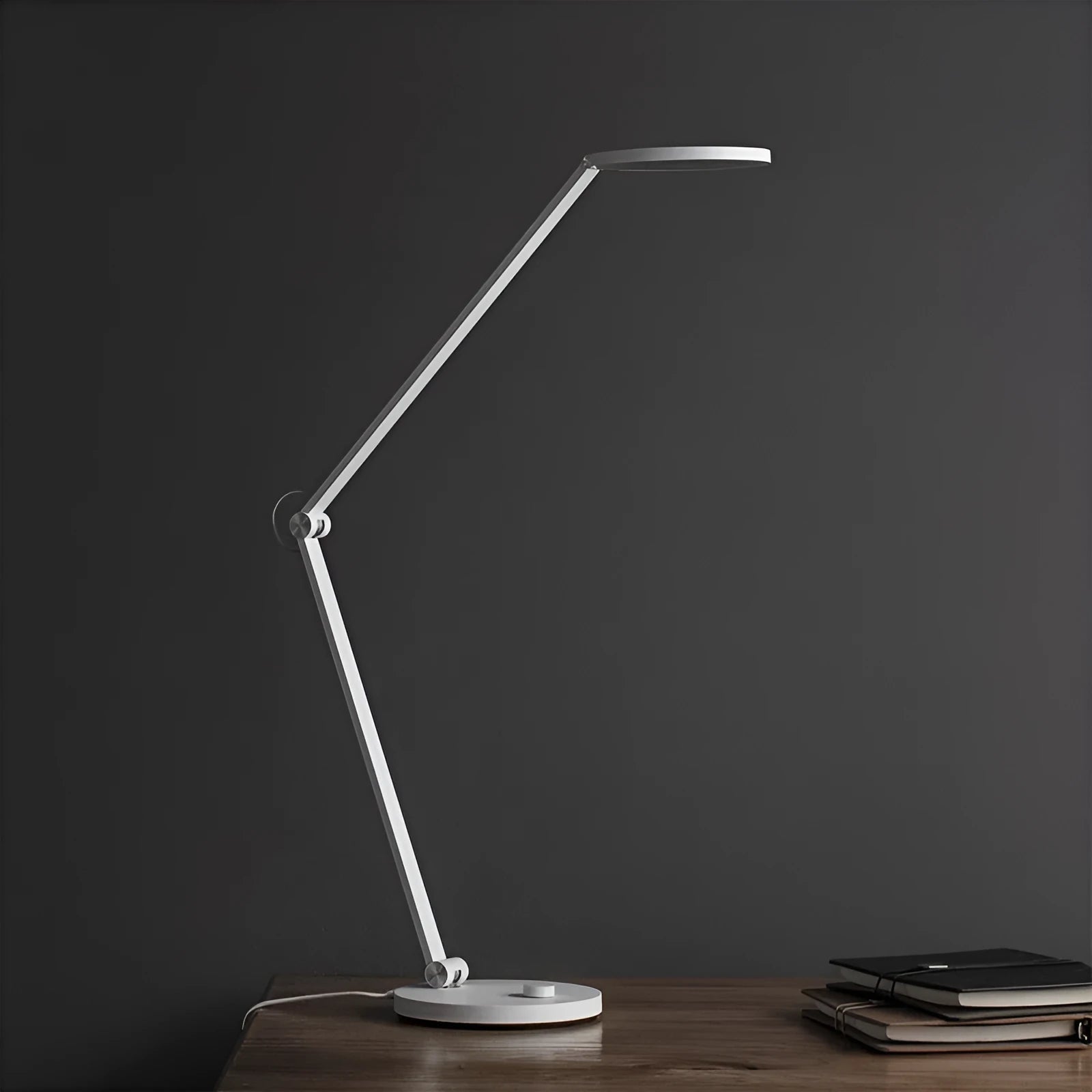 ProLED folding desk lamp with adjustable smart controls on a wooden desk.