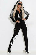 Black women's hooded casual suit with wings print pattern, featuring a zip top and matching trousers.