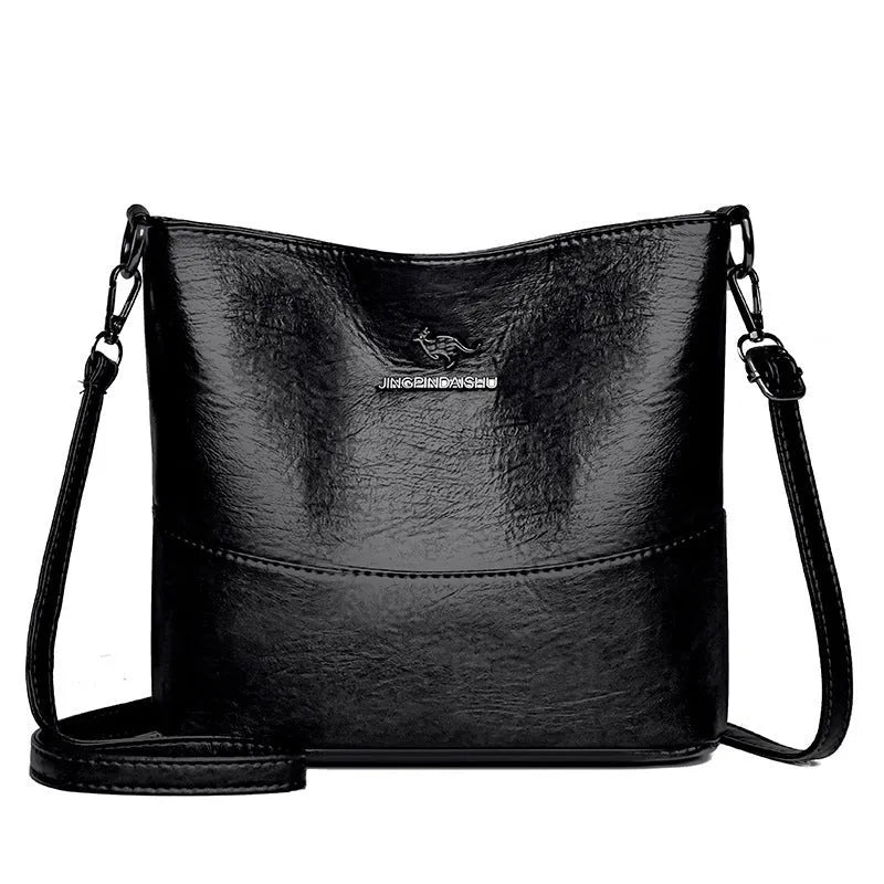 Women's soft leather bucket shoulder bag in black with visible sewing lines and phone compartment