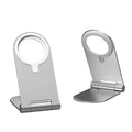 Silver vertical aluminium alloy magnetic phone bracket for iPhone 12 on a table.