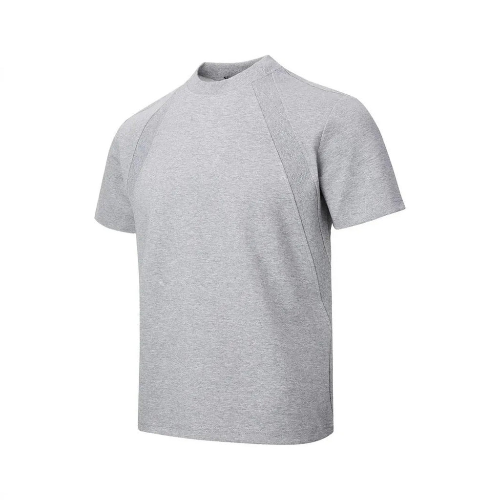 Man wearing a loose-fit black short sleeve top with visible air layer stitching detail.