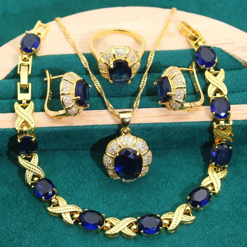 18k gold plated jewellery set with multi-colour zircon stones including necklace, earrings, bracelet, and ring on a display.
