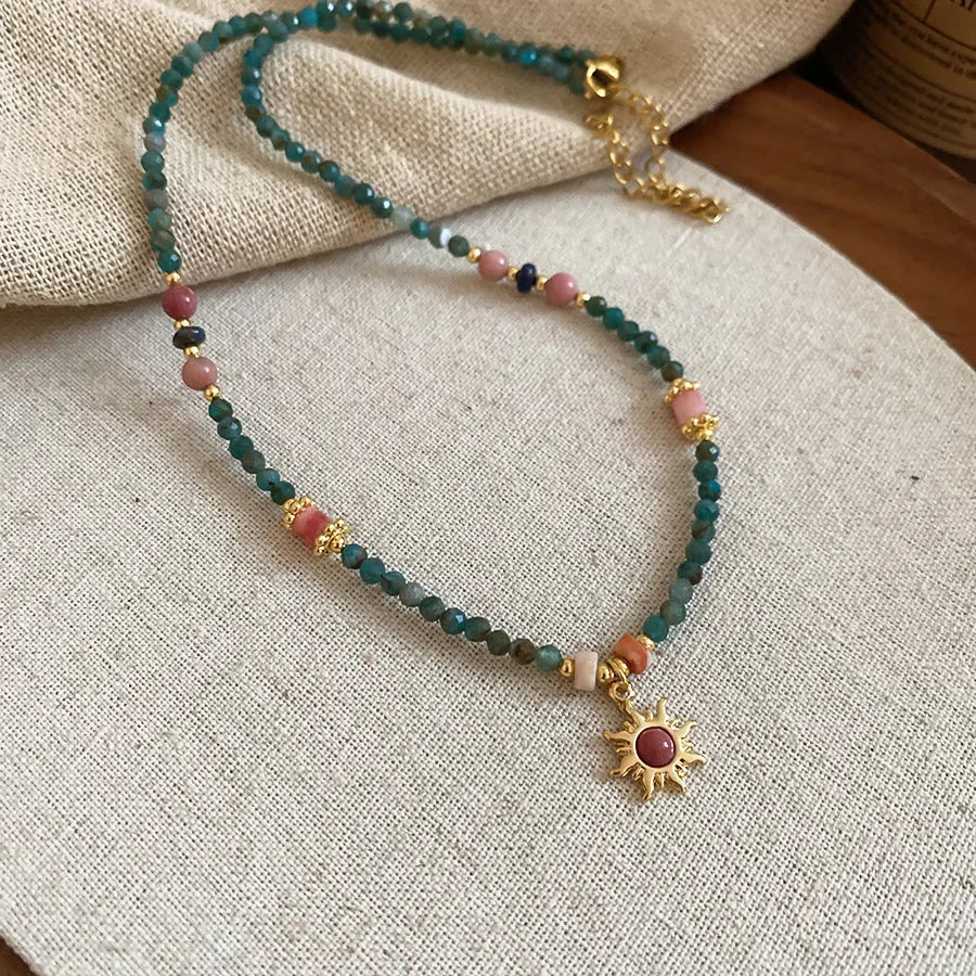Freshwater pearl necklace with stone sun pendant, French court style, blue and golden-blue-pink colours