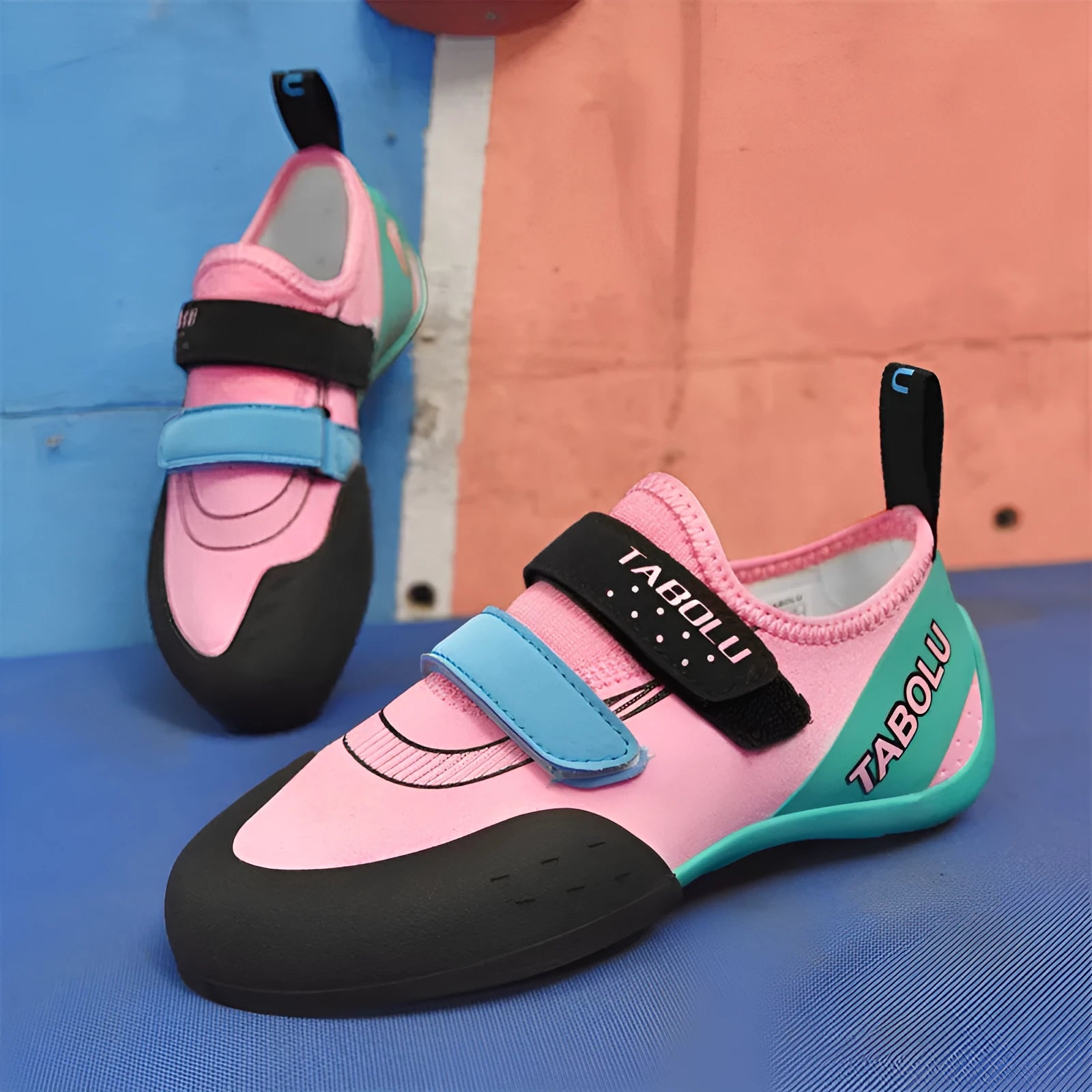 Beginner rock climbing shoes with Velcro fastening in black with red, orange yellow, or pink accents