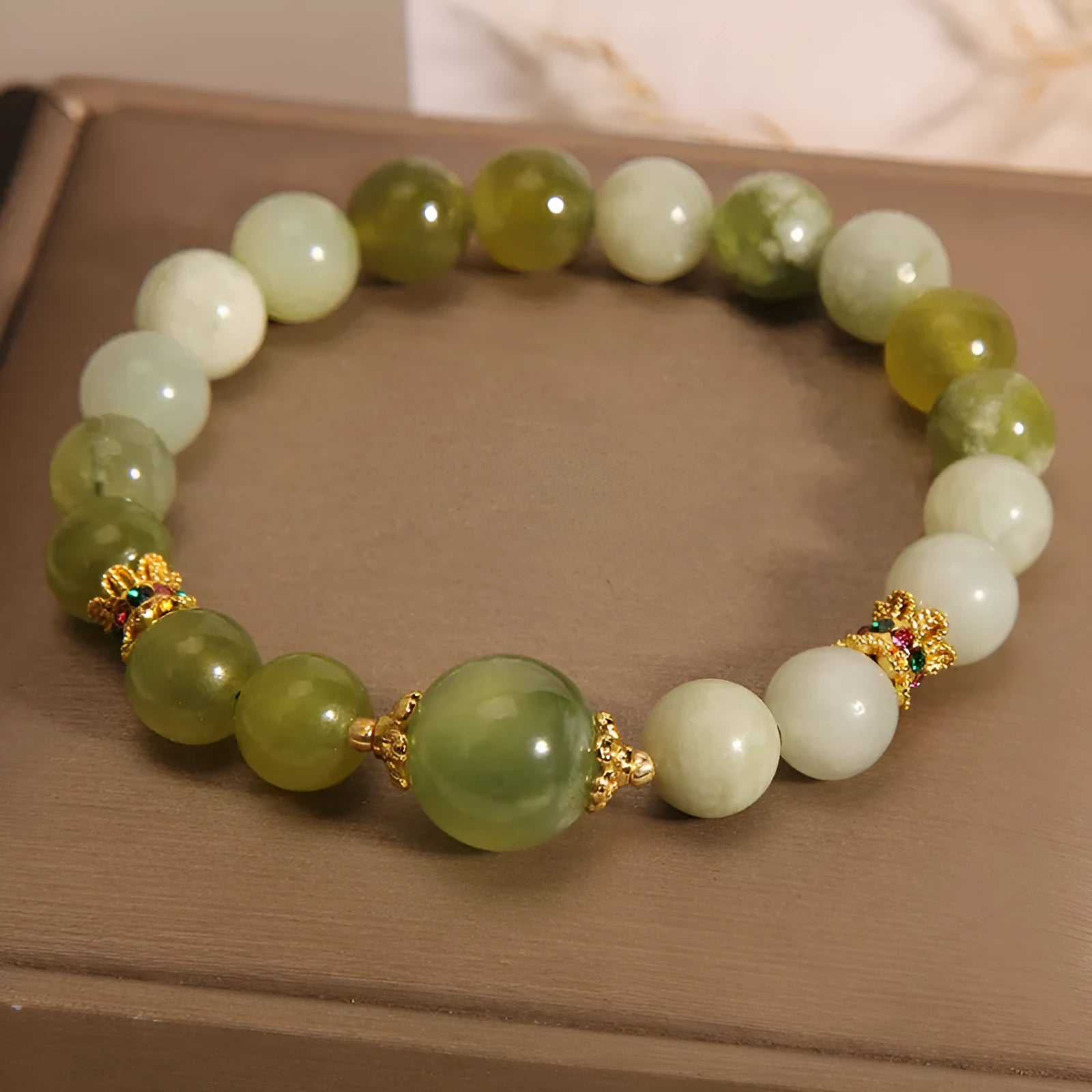 Women's Xiuyan jade bracelet in jade green with an original sweet mori style design.