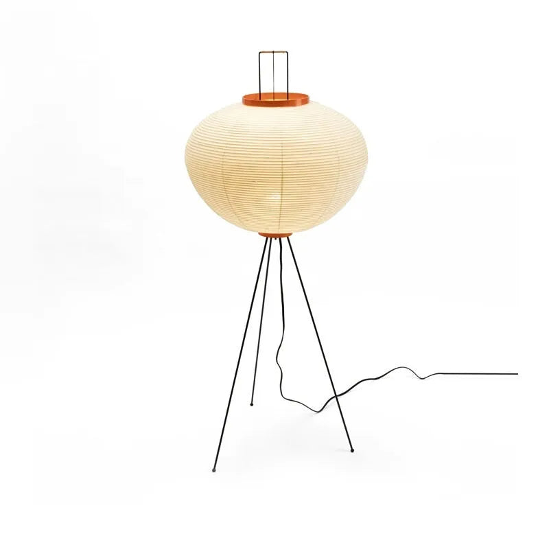 Japanese style table lamp with handmade paper shade and aluminium base on a wooden surface.