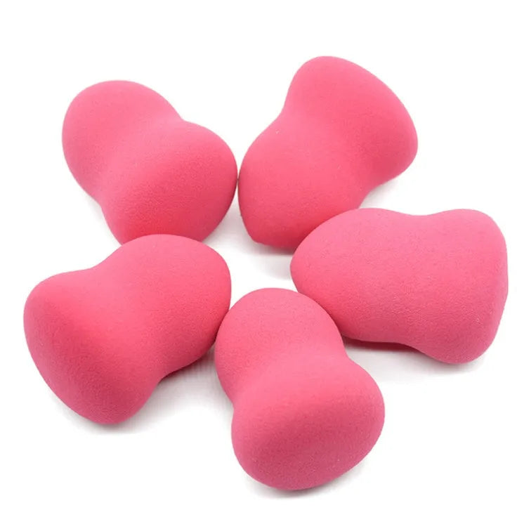 Pink cubic makeup sponge for foundation application, shown with dimensions 4cm by 4cm by 5.6cm.