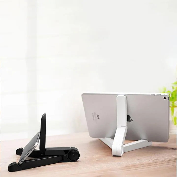 Black foldable tablet stand holding a smartphone in landscape mode on a desk, showing its compact folded size.